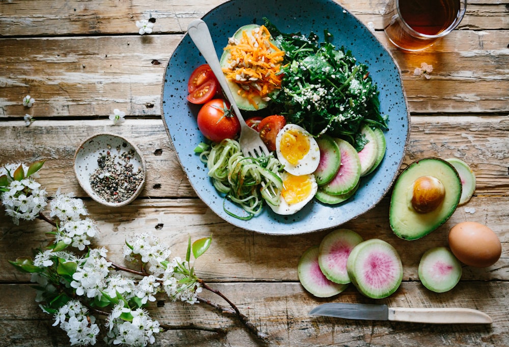 Bowl of colorful fresh vegetables and whole foods